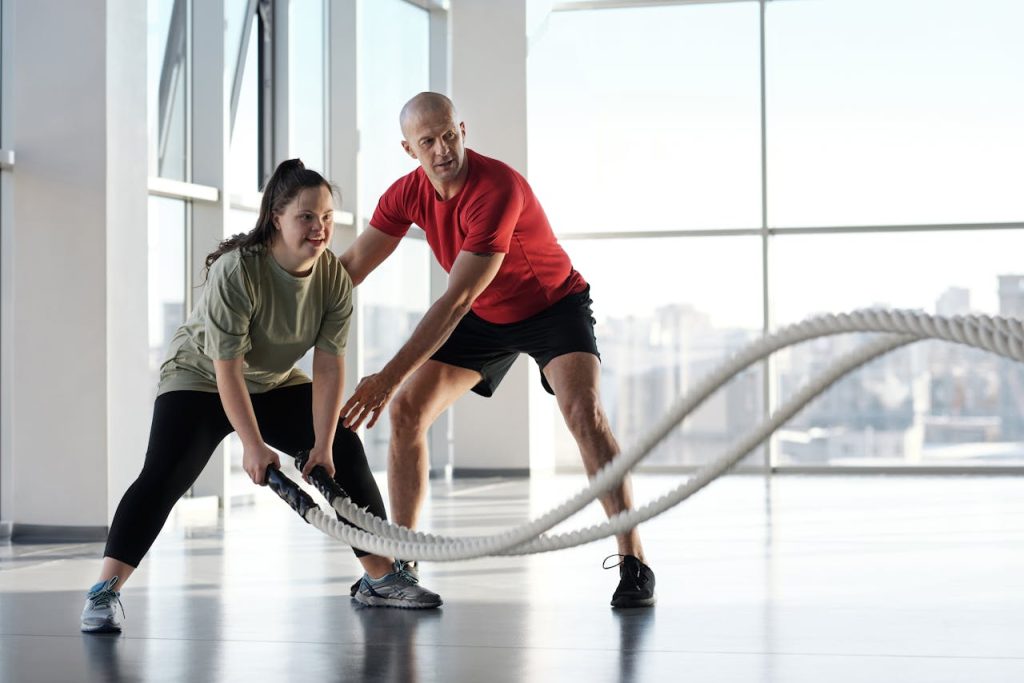 Personal Training Trends Featured Image of male trainer coaching female client with battle ropes